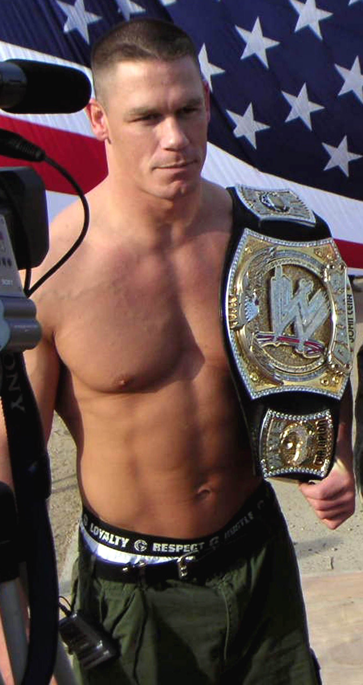 John Cena holding the spinner WWE Championship belt