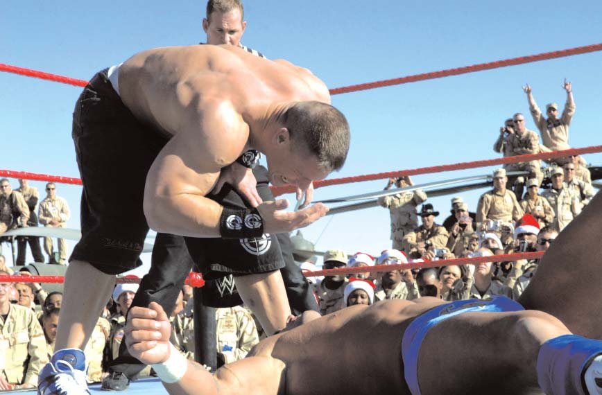 John Cena performs the You Can't See Me gesture on Chris Masters at Tribute to the Troops in 2005