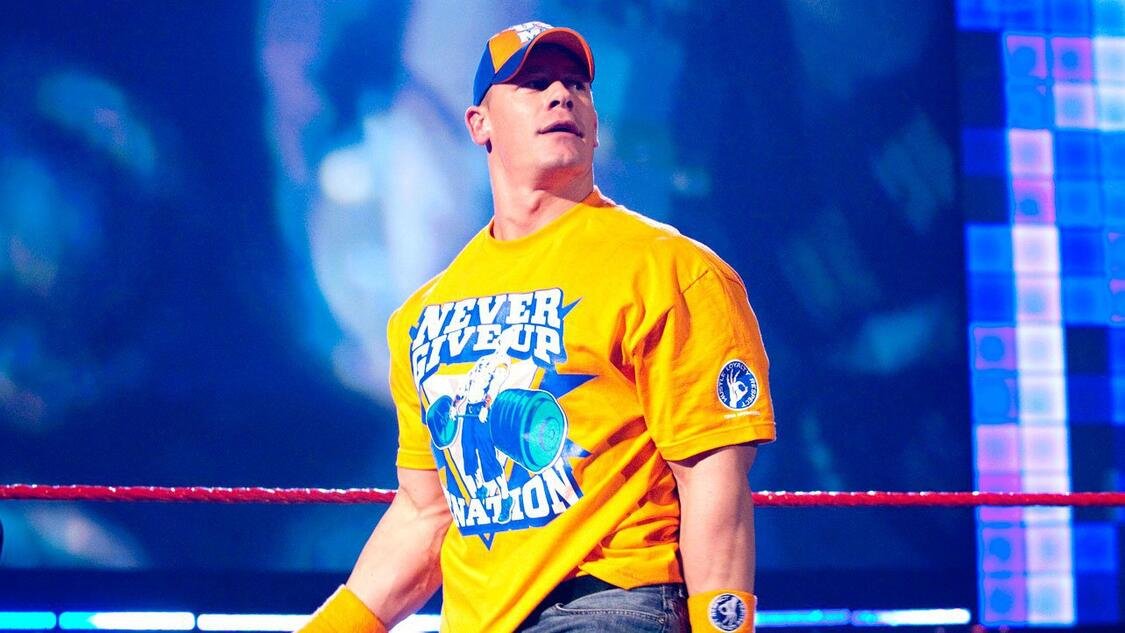 John Cena wearing his orange Never Give Up shirt