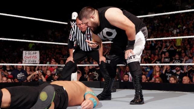 Kevin Owens performs John Cena's You Can't See Me gesture over Cena